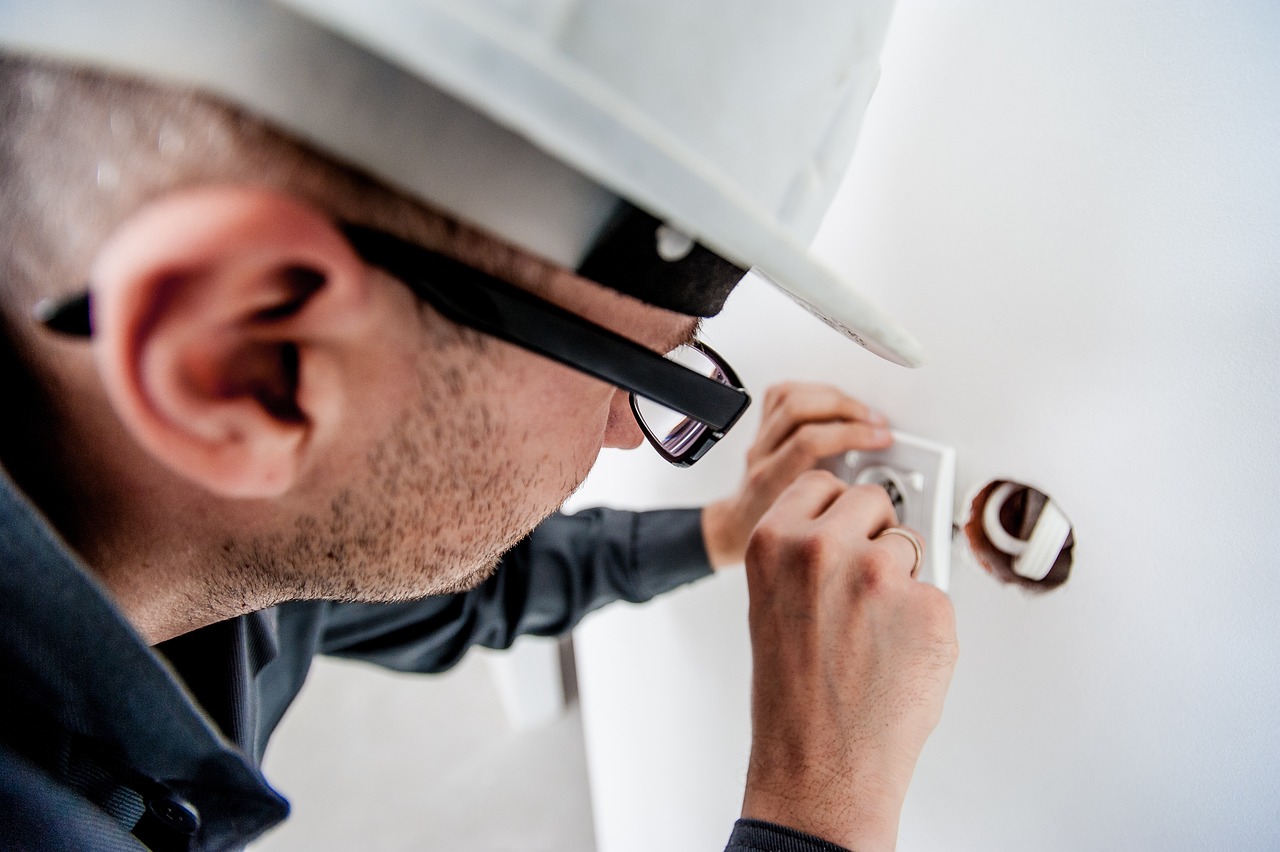 Electrician fitting a wall outlet